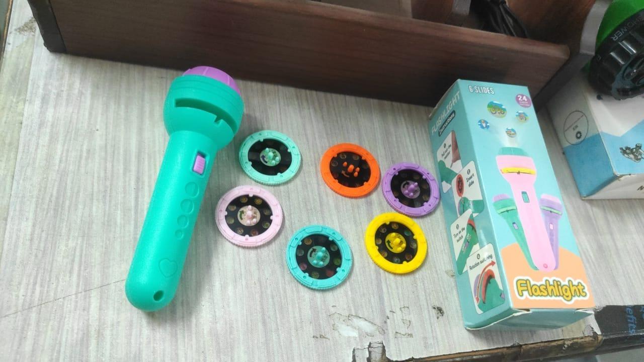 Children's toy microphone with colorful attachments on a wooden surface